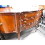 A mahogany serpentine shaped sideboard, in George III style, on square tapering legs, 131cm wide.