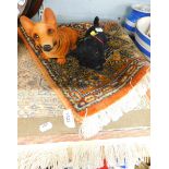 A small Turkomen rug and two nodding head dog figures.