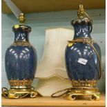 A pair of lamp vases with cream shades.