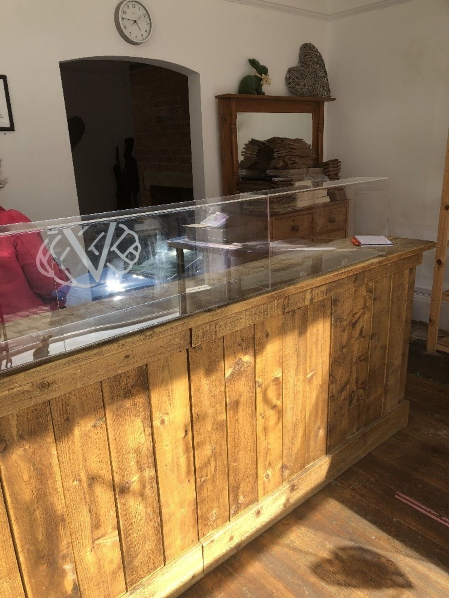 The residual contents of the shop and store room, being two wooden counters, four shelved racks, sto