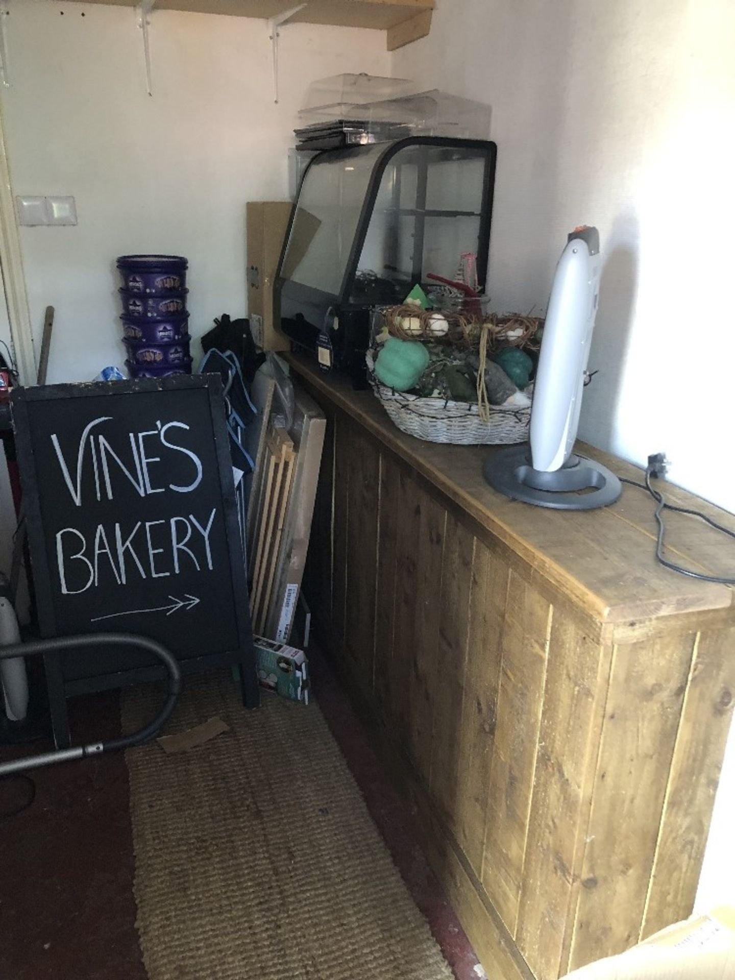 The residual contents of the shop and store room, being two wooden counters, four shelved racks, sto - Image 4 of 4