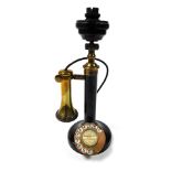 A vintage cast iron and brass candlestick telephone, the dial showing for Woodhall Spa 007.