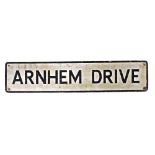 A mid century street sign, for Arnhem Drive, black on a white background, 105cm wide.