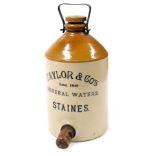 A Taylor and Company Mineral Waters dispenser, two tone stoneware, with metal carrying handle, and w