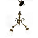 A brass three branch chandelier, with white opaline glass floral shades, approximately 45cm wide.