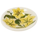 A Moorcroft Pottery dish decorated in the Bermuda Lily pattern, painted and impressed marks, 24.5cm