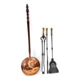 A set of Victorian cast iron fire implements, with foliate embossed brass handles, comprising shovel