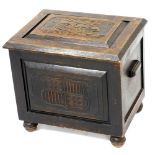 An early 20thC oak coal box, carved to the lid with a galleon, coat of arms to the front, raised on