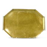 An Arts and Crafts brass twin handled octagonal tray, with engraved foliate decoration, 60.5cm wide.