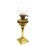A Veritas brass oil lamp, with a clear and etched chimney shade, 63cm high.