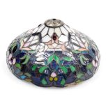 A Tiffany style glass table lamp shade, floral and jewelled decoration, 31cm wide. (AF)