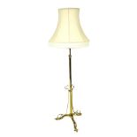A Victorian Arts and Crafts brass standard lamp, with shade, 175cm high.