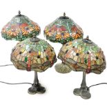 A pair of Tiffany style table lamps, the shades decorated with flowers, 50cm high, and further pair