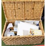 A wicker storage box, opening to reveal assorted paints and artists materials, 83cm wide, 44cm deep.