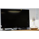 A Hitatchi 32" flat screen television, 32HB6J61U, with lead and remote, and a ship's decanter with a