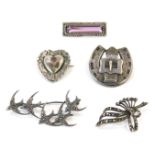 Five silver brooches, comprising two Victorian buckle brooches, a purple paste stone set bar brooch,