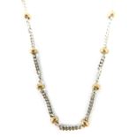 A 9ct gold bi-colour necklace, with curve links and ball breaks, on white and yellow gold, 60cm lon