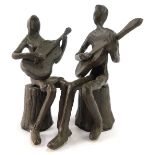 A cast bronzed metal figure group of two figures playing guitars, male and female folk duo, 13cm hig
