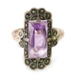 An amethyst and marcasite Art Deco style dress ring, the rectangular amethyst surround by marcasite