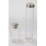 Two dressing table jars, each with a silver lid bearing the initials T E S, 17cm and 9cm high respec