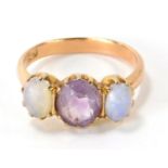 A 9ct gold amethyst and moonstone three stone dress ring, with three oval cut stones in claw setting
