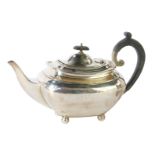 A George V silver teapot, London shape, with ebonised handle and knop, on ball feet, Sheffield 1924,