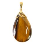 A tiger's eye tear drop pendant, on a yellow metal clip pendant mount, marked 375, 5cm high, 10g all