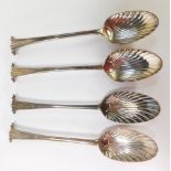 A set of four Victorian silver scroll top shell bowl serving spoons, indistinct hallmarks, London 18