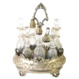 A Victorian silver plated eight bottle cruet, with shell capped carry handle, decanter and vinaigret