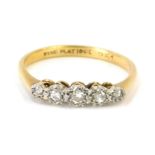 An 18ct gold and plat diamond five stone dress ring, set with five illusion set diamonds in platinum