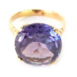 A multifaceted mystic topaz ring, round brilliant cut in four claw raised basket setting, with etche