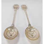 A pair of silver plated Art Nouveau serving spoons, each with pierced Art Nouveau top and bowl, stam