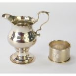 A George III silver cream jug, with fluted top and acanthus leaf handle, on a stepped foot, London 1