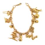 A 9ct gold charm bracelet, with fancy link two loop and three row joined chain, with various charms