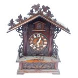 A 19thC Black Forest pine mantel clock, the arched top with vine and berry detail, with bone Roman n