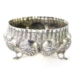 An Eastern white metal bowl, with fluted and hammered palm tree design, on tripod base, unmarked, 1¾