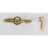 A 9ct gold bar brooch, set with central peridot on scroll design, 4cm diameter, and a wishbone penda