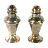 A pair of George V silver salt and pepper pots, each of baluster form, London 1916, 1 ½oz.