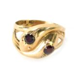 A 9ct gold snake ring, the head formed of two snake heads set with garnets, size T, 6.2g all in.