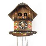A Dutch cuckoo clock, with painted tulip design and weights.