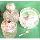 Two silver topped cut glass dressing table jars, a chrome topped cut glass dressing table jar and a