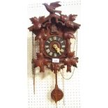 A Black Forest pine cuckoo clock, with swallow branch top, weights and pendulum.