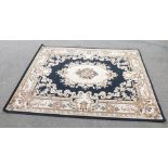 A green ground floral pattern machine made rug, 160cm x 160cm.