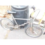 A child's Raleigh bicycle, yellow and silver.