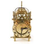 A 20thC brass lantern clock, of small proportion, with 7cm diameter Roman numeric dial, and electric