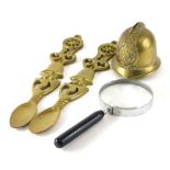 Various brassware, a police helmet money box, 12cm high, spoon wall hangings and a large magnifying