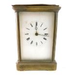 An early 20thC brass carriage clock, the 6.5cm back plate with Roman numeric dial fitted in a five p