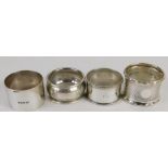 Four various George V silver napkin rings, Birmingham 1923 and others, 3cm high, etc., 3.24oz. (4)