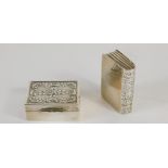 A novelty book shaped patch box, partially chased, marked 925, 3cm, and a further patch box, repouss