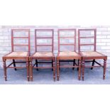A set of four late 19th/early 20thC mahogany ladder back dining chairs, each with a rush seat on tur